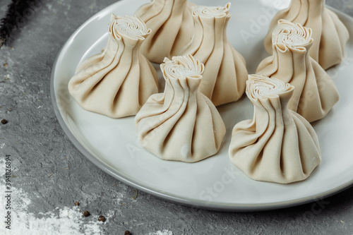 Caucasuan cuisine - Khinkali with meat on a white plate photo