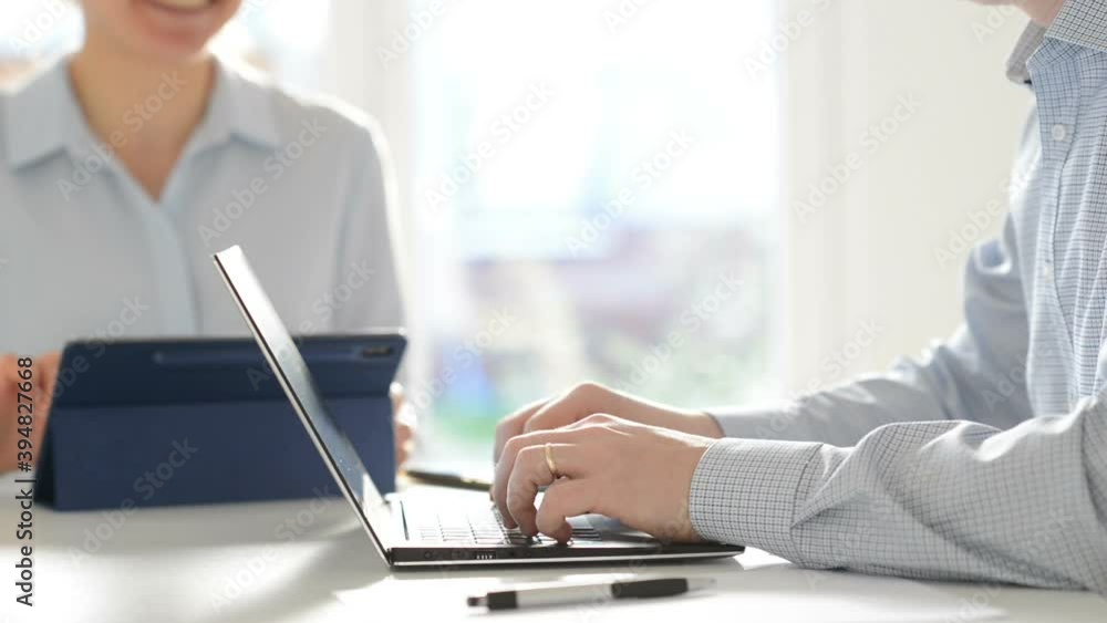 Happy woman and man working with laptop and tablet at home office. Woman calling with mobile phone Happy woman and man working with laptop and tablet at home office. Woman calling with mobile phone