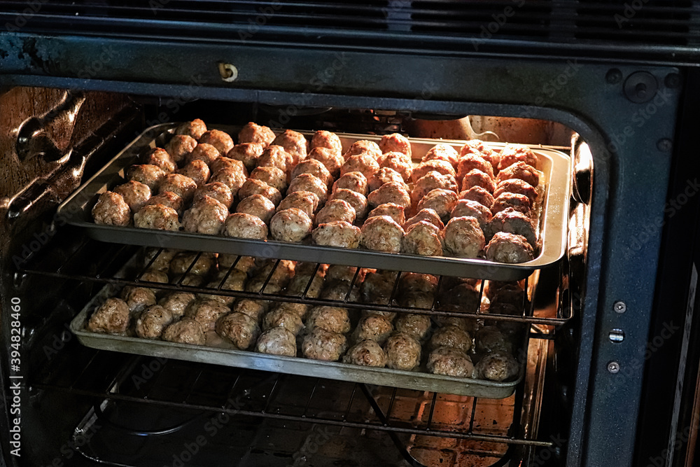 On oven baking two trays of meatballls