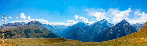 Hiking near ski station Les deux Alpes and view on Alpine mountains peaks in summer, Isere, France