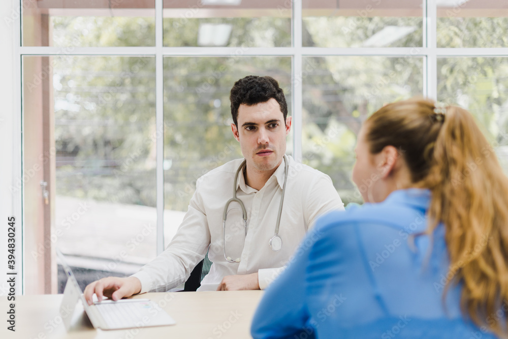 Doctors are explaining and analyzing the patient's illness. The doctor put a stethoscope on his neck. Doctors are explaining and analyzing the patient's illness. The doctor put a stethoscope on his neck.
