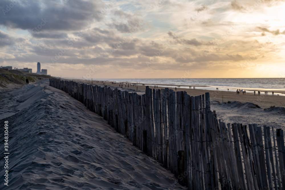 Sand fence on wide windy beach of North sea near Zandvoort in Netherlands Sand fence on wide windy beach of North sea near Zandvoort in Netherlands
