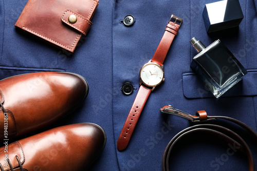 Flat lay composition with luxury wrist watch on blue shirt