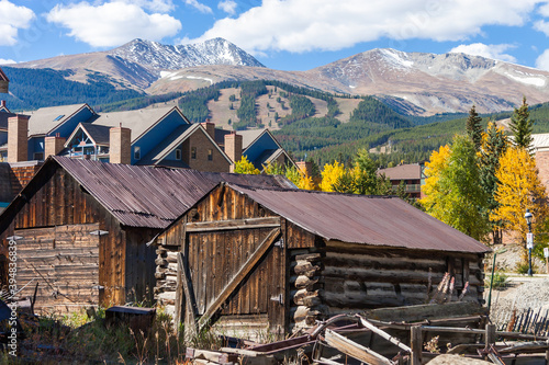 Breckenridge Old & New - Old log cabins in front of a modern condo building in the Town of Breckenridge Colorado with the ski slopes on the mountain above, in Autumn photo