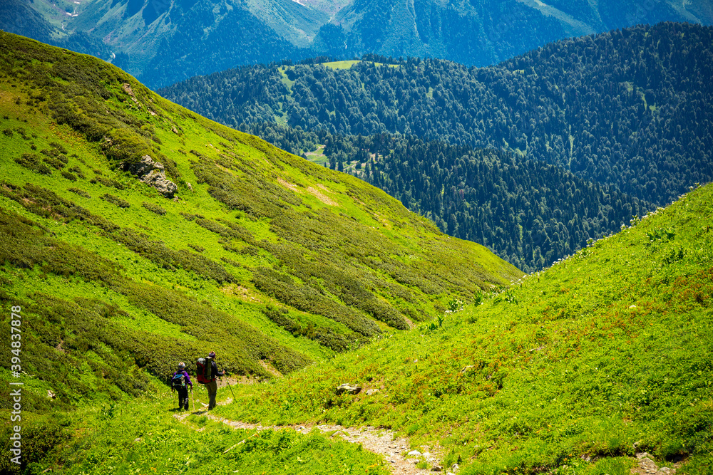 Beautiful mountain landscape with tourists hiking Beautiful mountain landscape with tourists hiking