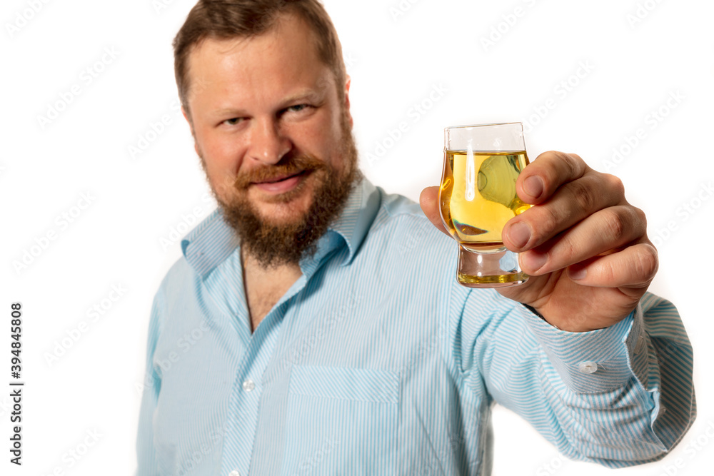 Solid bearded man in shirt tasting whisky studio portrait Solid bearded man in shirt tasting whisky studio portrait