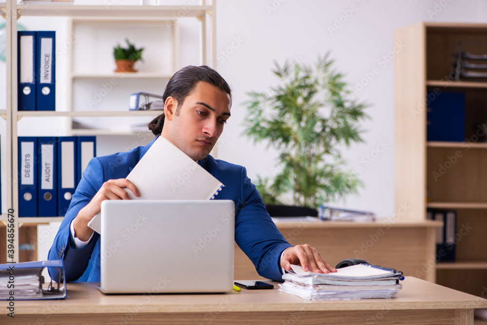 Young handsome employee sitting in the office Young handsome employee sitting in the office