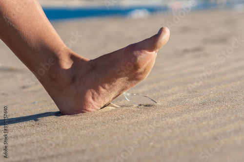 Photography Woman going on the beach and risking of stepping on a splinter of broken bottle