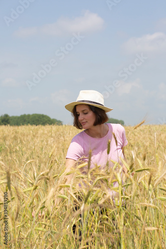  A girl walking in a field with wheat