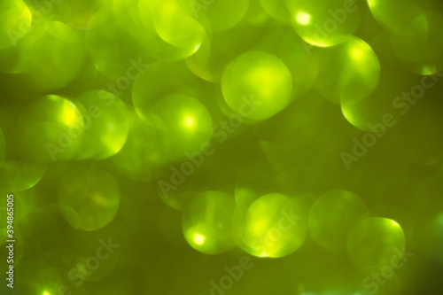 Shimmering blur spot light on ligtht green color background, Christmas concept