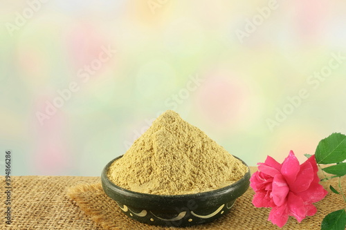 fuller earth or multani mitti for herbal ayurvedic face pack with rose in blur background with copy space photo