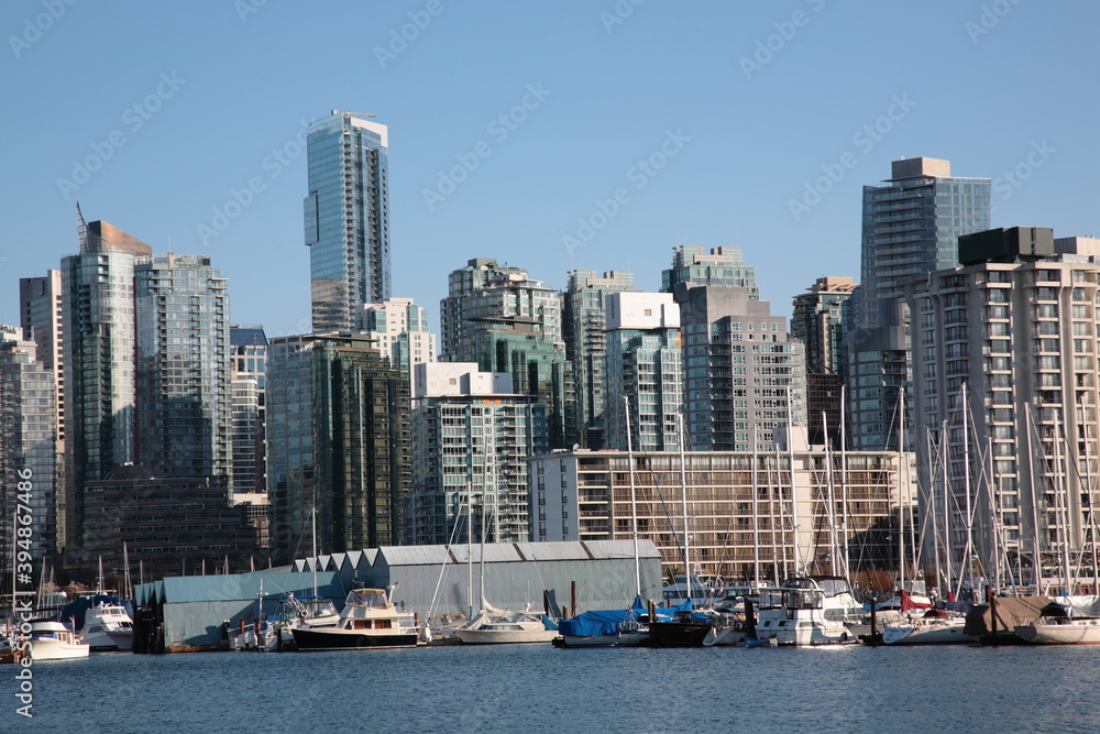 View of Vancouver downtown skyline and coal harbour seen from Vancouver Stanley Park, British Columbia,  Canada.