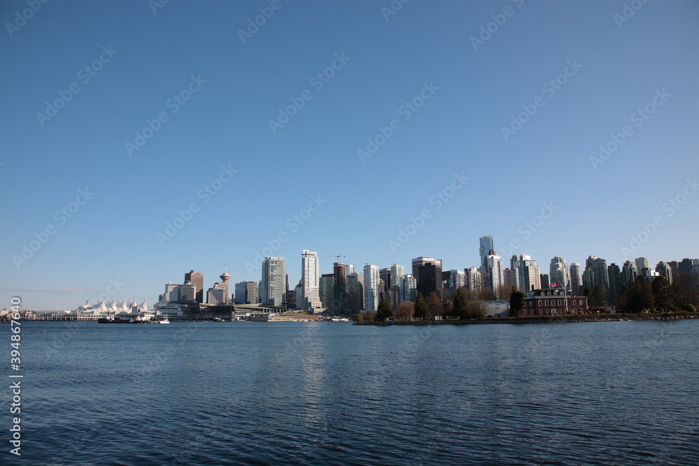 View of Vancouver downtown skyline and coal harbour seen from Vancouver Stanley Park, British Columbia, Canada. View of Vancouver downtown skyline and coal harbour seen from Vancouver Stanley Park, British Columbia, Canada.