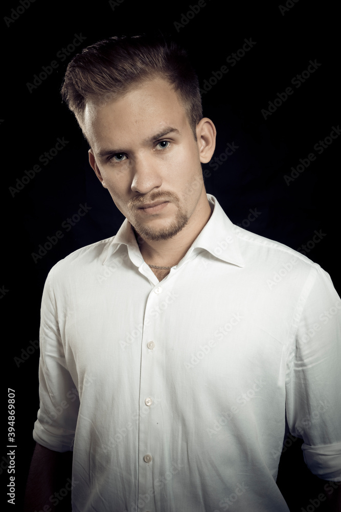 Fototapeta premium Young man dressed in white shirt studio portrait