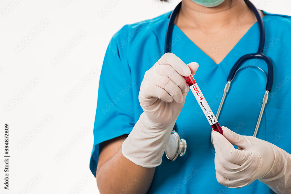 Nurse in blue uniform wear a mask holding test tube sample Coronavirus test blood in the laboratory for analyzing isolated on white background, medicine COVID-19 pandemic outbreak concept Nurse in blue uniform wear a mask holding test tube sample Coronavirus test blood in the laboratory for analyzing isolated on white background, medicine COVID-19 pandemic outbreak concept