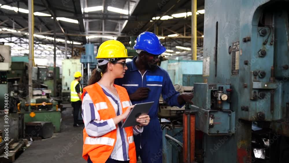 Professional technicians and engineers group wearing protective clothing are working in the industrial plants. Hold the tablet in your hand to see how the machine works. Professional technicians and engineers group wearing protective clothing are working in the industrial plants. Hold the tablet in your hand to see how the machine works.
