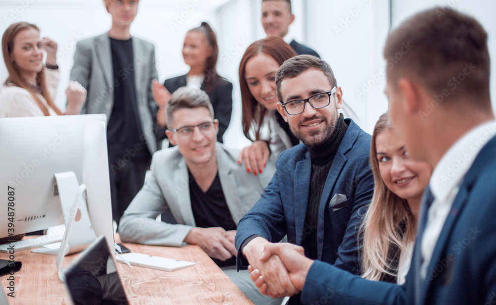 business people shaking hands sitting at the office Desk. business people shaking hands sitting at the office Desk.