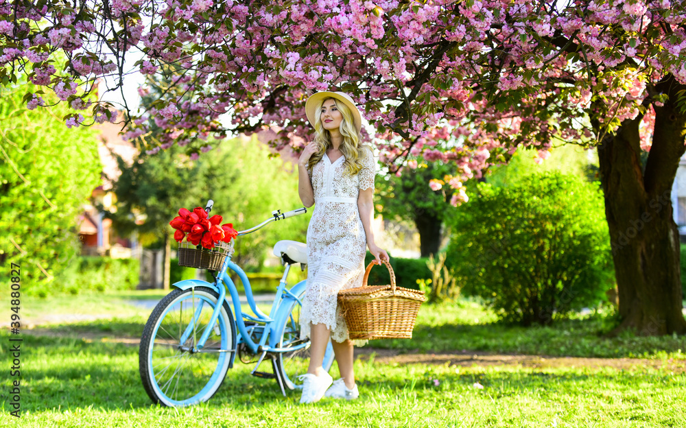 I am free. perfect smell. perfume spa and allergic. travel. retro woman sell tulip flower bouquet. girl under sakura with vintage bicycle. spring beauty and fashion. cherry tree pink blossom
