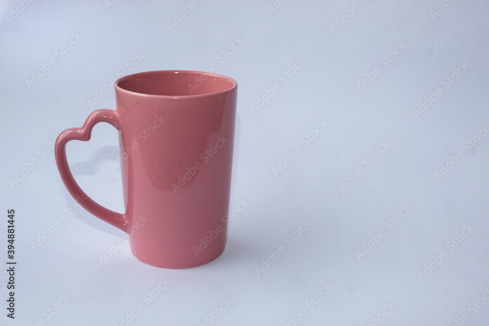 Fototapeta premium A pink mug on a white background.