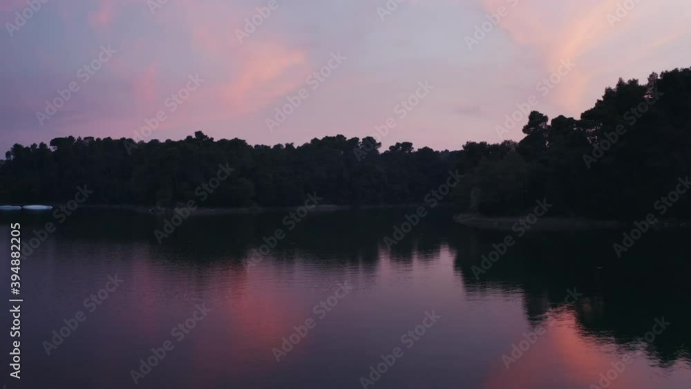 Low-flying aircraft on a Glassy lake during the sunset in Carcassonne France, early morning drone shot with beautiful colors Low-flying aircraft on a Glassy lake during the sunset in Carcassonne France, early morning drone shot with beautiful colors