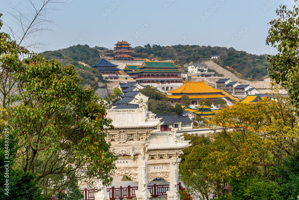Naklejka premium Chinese traditional colorful Baotuo lecture temples in the Putuoshan mountains, Zhoushan Islands, a renowned site in Chinese bodhimanda of the bodhisattva Avalokitesvara (Guanyin)