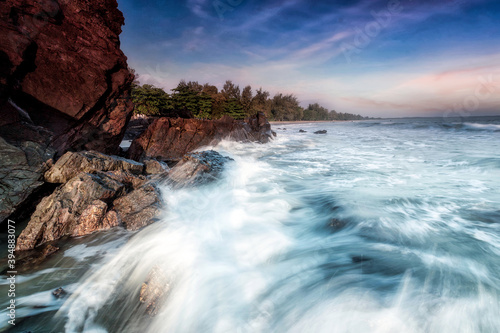 A scenic beauty of splashing wave over coastal rock at Batu Layar beach, Kota Tinggi. Johore