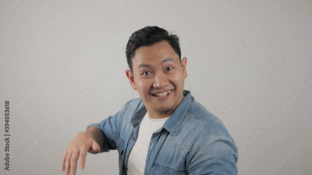 Funny young Asian man dancing happily joyful expressing celebrating good news victory winning success gesture Funny young Asian man dancing happily joyful expressing celebrating good news victory winning success gesture