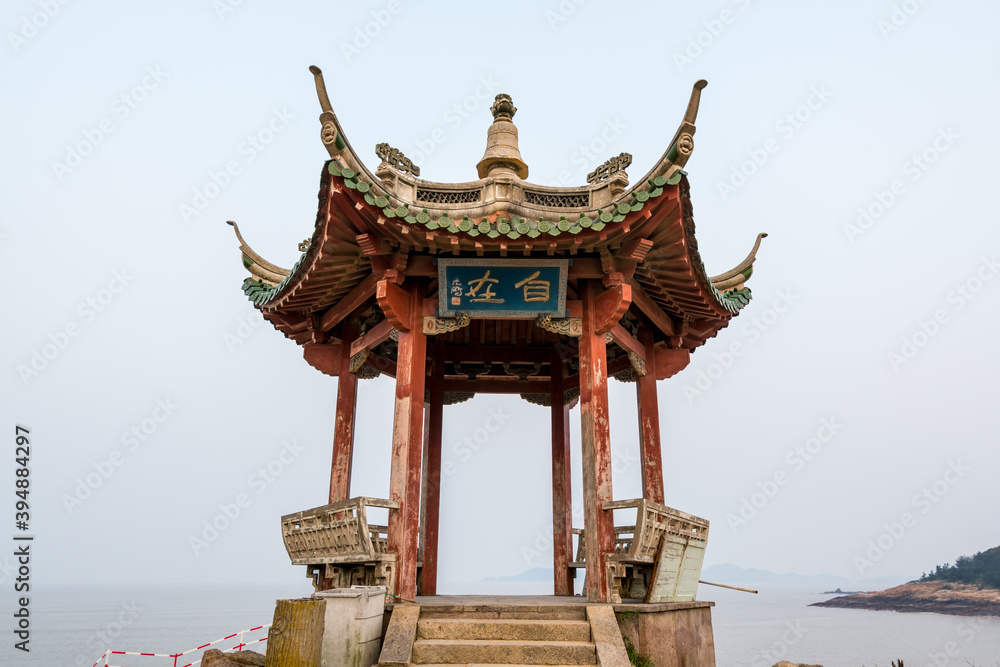  A Chinese traditional pavilion at the seaside in Putuoshan, Zhoushan Islands, Zhejiang, China (Character: Freedom)