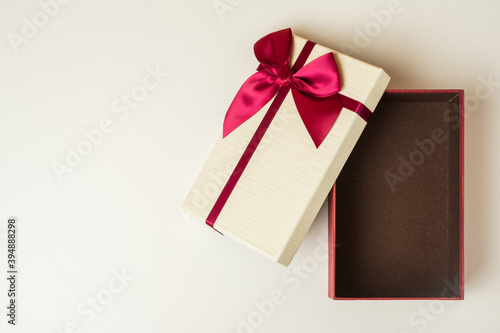 Open Gift box mockup on the white table with copy space. Merry christmas and happy new years background for text advertise.