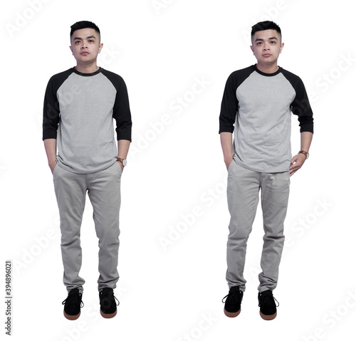 Young handsome man wearing black grey raglan t shirt isolated on plain background
