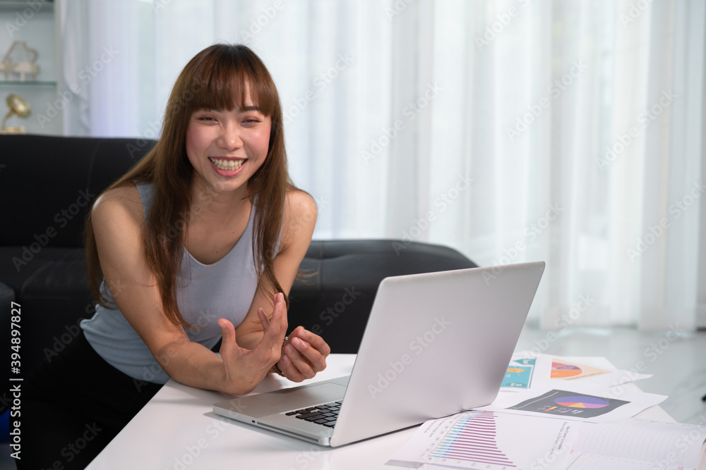 Work from Home, Beautiful young woman working on laptop computer while sitting at the living room, Online meeting from home. Work from Home, Beautiful young woman working on laptop computer while sitting at the living room, Online meeting from home.