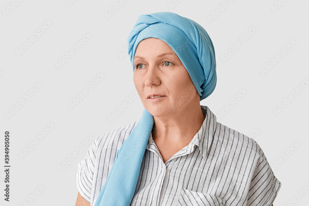 Sad mature woman after chemotherapy on light background Sad mature woman after chemotherapy on light background