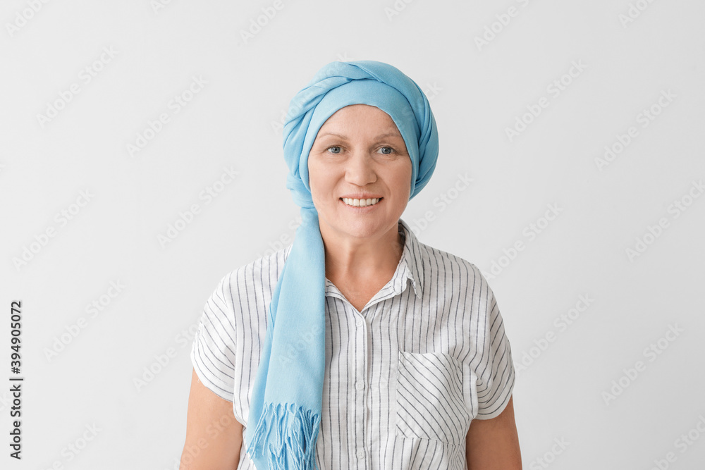 Happy mature woman after chemotherapy on light background Happy mature woman after chemotherapy on light background