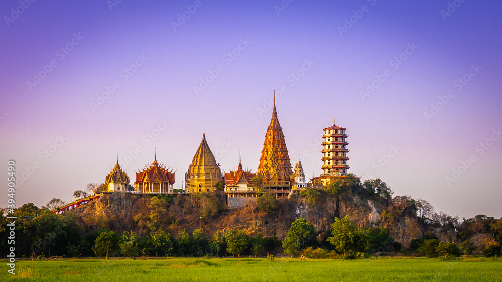 Panorama Landscape of Wat Tham Sua at dusk is a very beautiful and popular landmark for tourists in Kanchanaburi, Thailand.