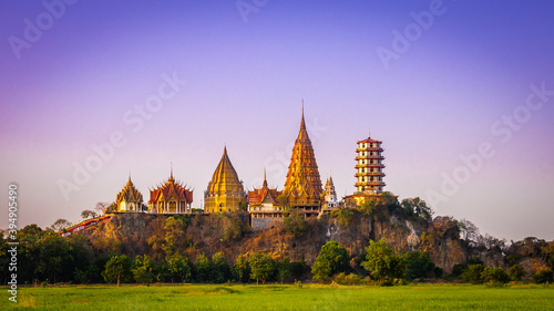 Panorama Landscape of Wat Tham Sua at dusk is a very beautiful and popular landmark for tourists in Kanchanaburi, Thailand.