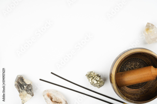 Singing bowl, heailng gemstones, incense frame on white background. Meditation, spirituality concept. Top view, flat lay, copy space
