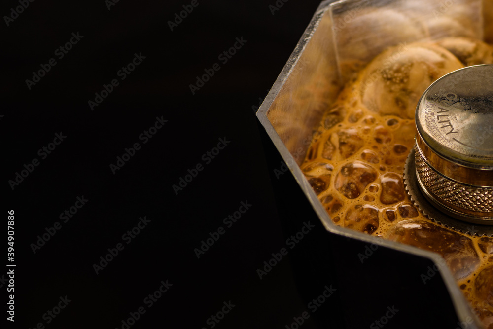 Fresh coffee with rich foam brewed in a coffee pot Fresh coffee with rich foam brewed in a coffee pot