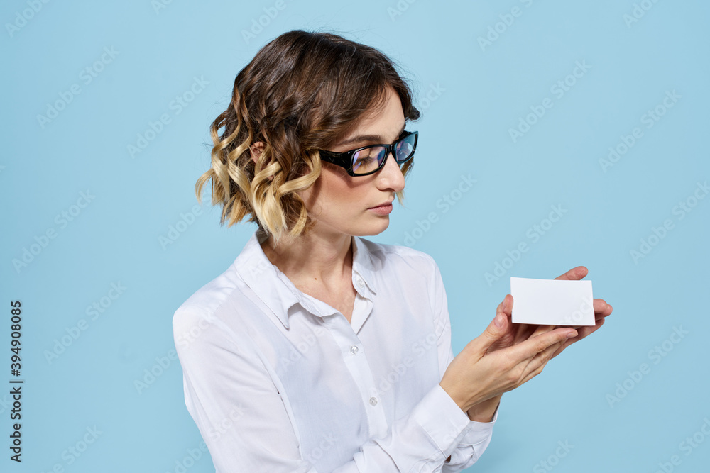 Woman wearing business card glasses in hands on blue background Copy Space cropped view