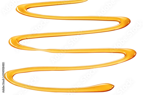 Decorative zigzag drizzle of golden honey on white
