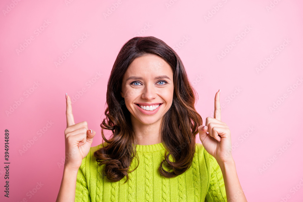 Photo of charming wavy lady wear green sweater looking pointing two fingers up empty space isolated pink color background Photo of charming wavy lady wear green sweater looking pointing two fingers up empty space isolated pink color background