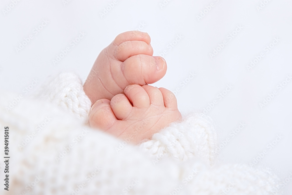 Newbornfeet baby in cotton pants on white background Newbornfeet baby in cotton pants on white background