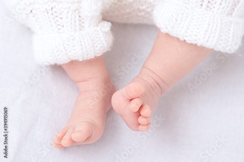 Newbornfeet baby in cotton pants on white background