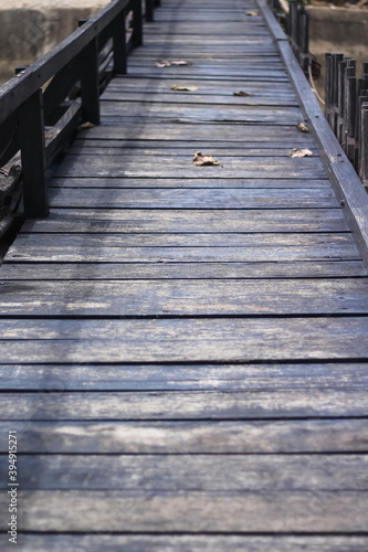 Fototapeta Naklejka Na Ścianę i Meble -  Old wood plank bridge with dry leaf on floor background