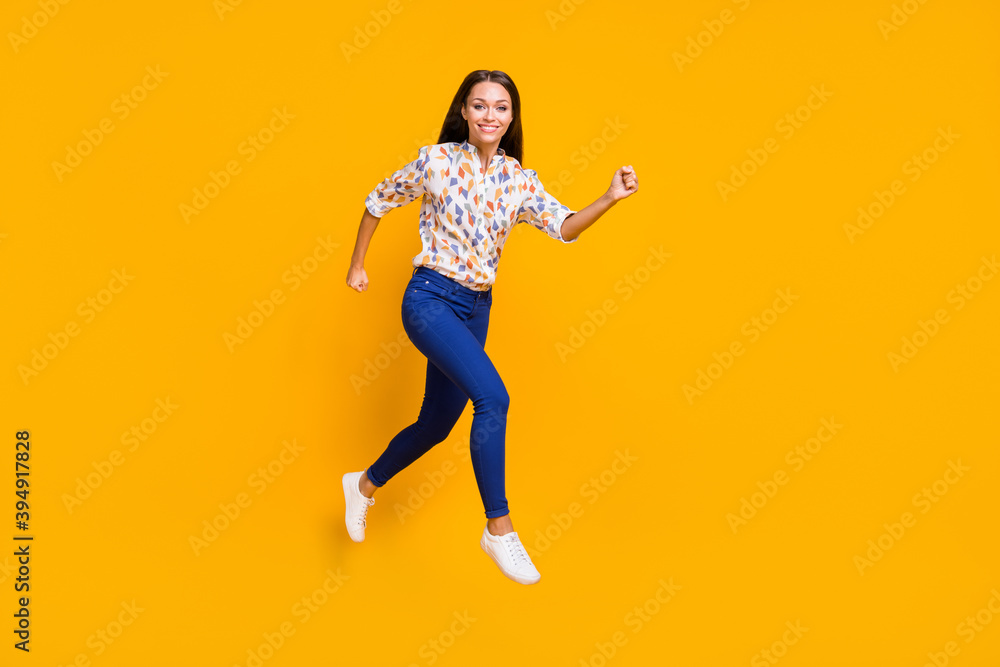 Photo portrait full body view of cute running girl jumping up isolated on vivid yellow colored background