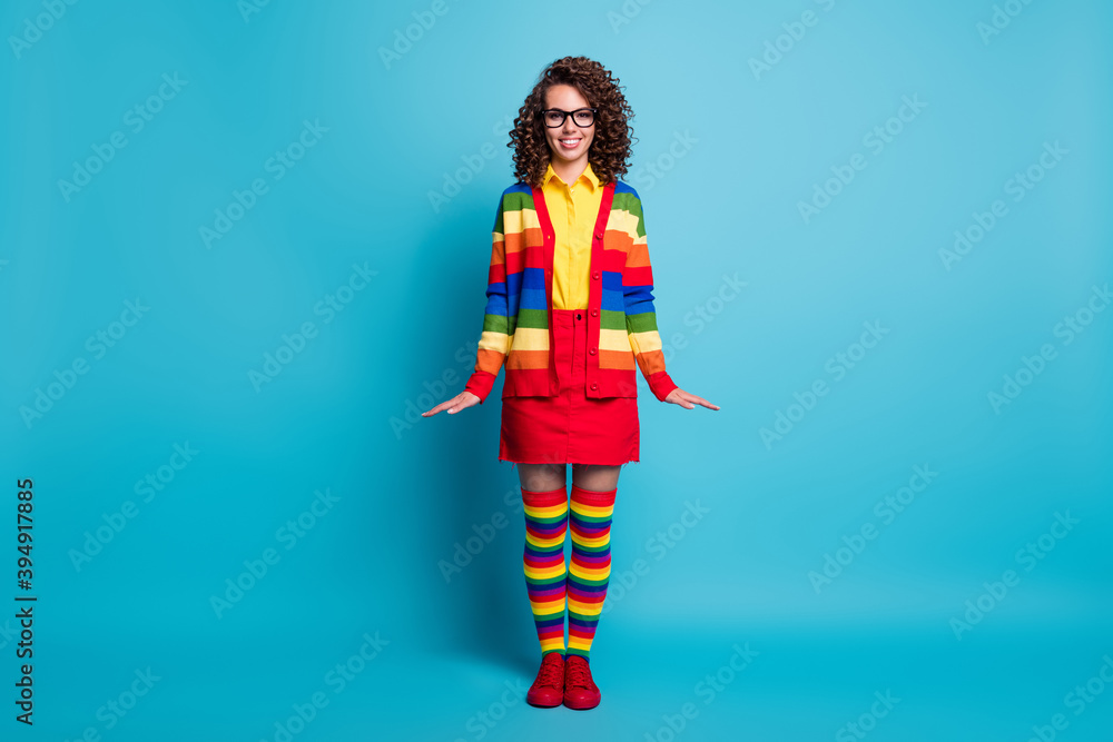 Full length body size view of attractive cheerful wavy-haired girl posing wear striped garment isolated on bright blue color background Full length body size view of attractive cheerful wavy-haired girl posing wear striped garment isolated on bright blue color background