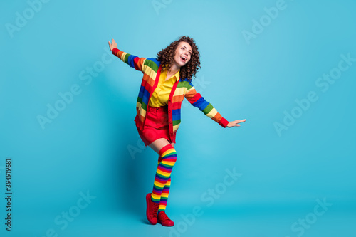 Fototapeta Naklejka Na Ścianę i Meble -  Full body photo of attractive young girl fly wing hands look empty space isolated over blue color background