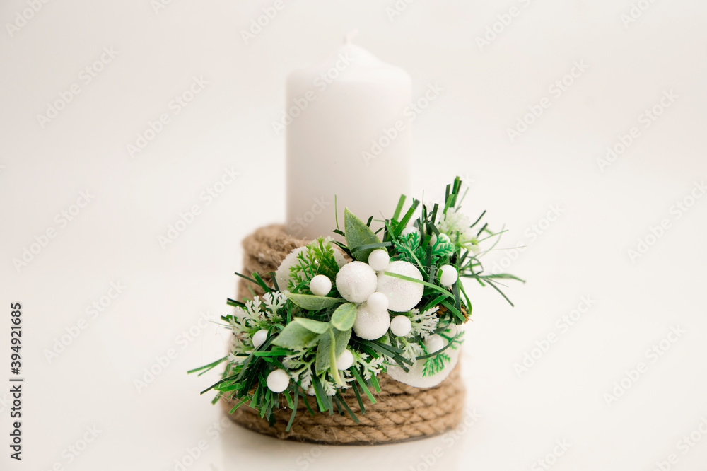 Christmas candles and decorations on a white background. Handmade candlestick.