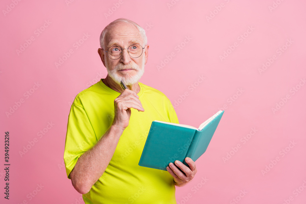 Portrait of serious pensioner write copybook look empty space wear spectacles green color t-shirt isolated on pastel pink color background Portrait of serious pensioner write copybook look empty space wear spectacles green color t-shirt isolated on pastel pink color background