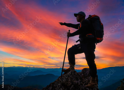 Young man hiker on a top of a mountain