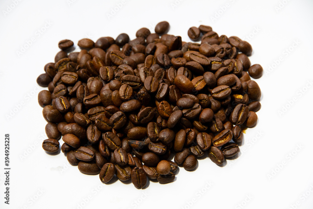 Roasted coffee beans heap isolated on white background Roasted coffee beans heap isolated on white background